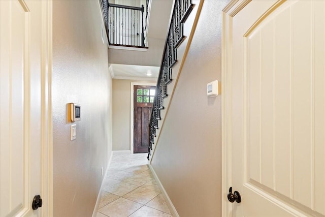 1516 Amundsen St, Houston, TX 77009 - hall featuring light tile patterned floors, stairway, and ornamental molding