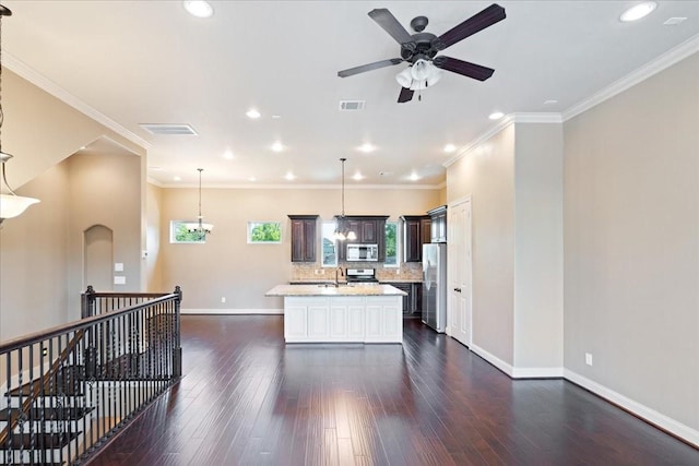 1516 Amundsen St, Houston, TX 77009 - kitchen with appliances with stainless steel finishes, ceiling fan, a center island with sink, recessed lighting, and dark wood-style flooring