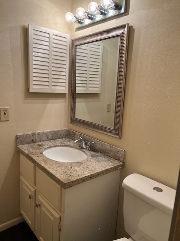 bathroom featuring toilet and vanity