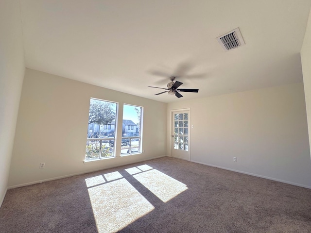 empty room featuring carpet flooring and ceiling fan