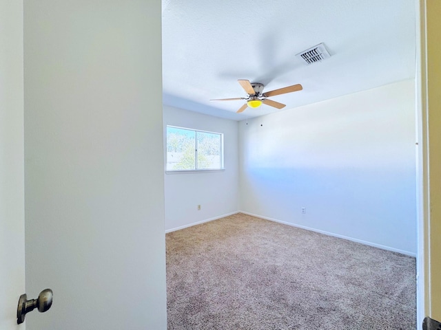 carpeted empty room with ceiling fan