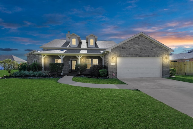 view of front of property featuring a yard and a garage