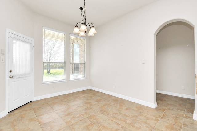 unfurnished dining area featuring a chandelier