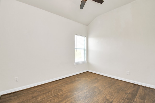 spare room featuring dark wood-type flooring, lofted ceiling, and ceiling fan