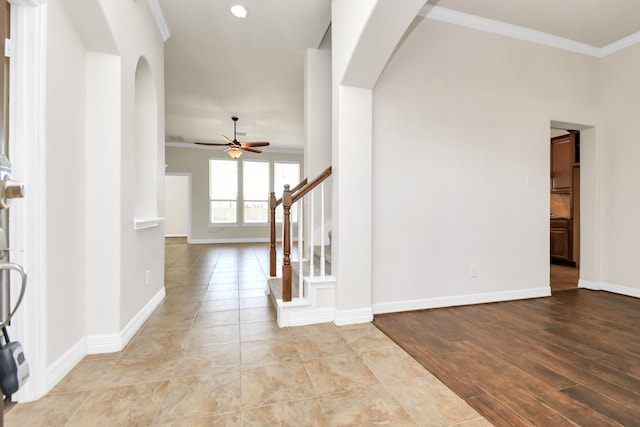 foyer with ceiling fan, ornamental molding, and light hardwood / wood-style flooring