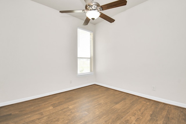 spare room with ceiling fan and dark hardwood / wood-style floors