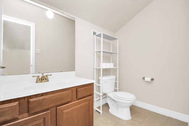 bathroom with vanity, toilet, tile patterned floors, and lofted ceiling