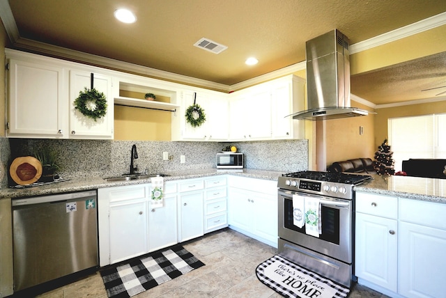 kitchen with white cabinets, sink, wall chimney exhaust hood, ornamental molding, and appliances with stainless steel finishes