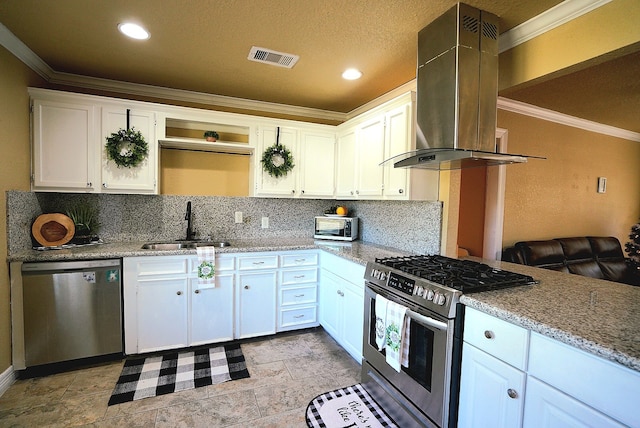 kitchen featuring wall chimney exhaust hood, sink, white cabinets, and appliances with stainless steel finishes