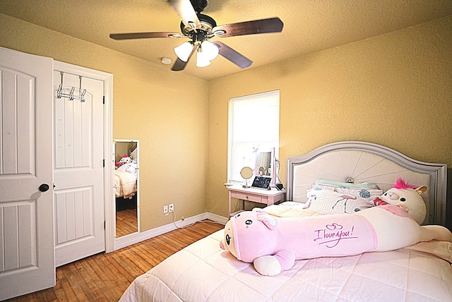 bedroom featuring hardwood / wood-style flooring and ceiling fan