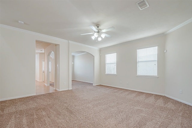 unfurnished room with light carpet, crown molding, and ceiling fan