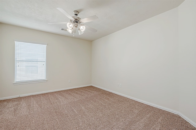 unfurnished room featuring ceiling fan, carpet floors, and a textured ceiling