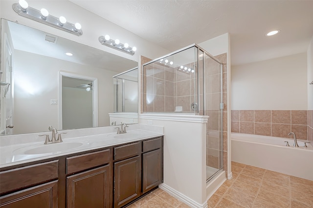 bathroom with ceiling fan, tile patterned floors, a textured ceiling, vanity, and independent shower and bath