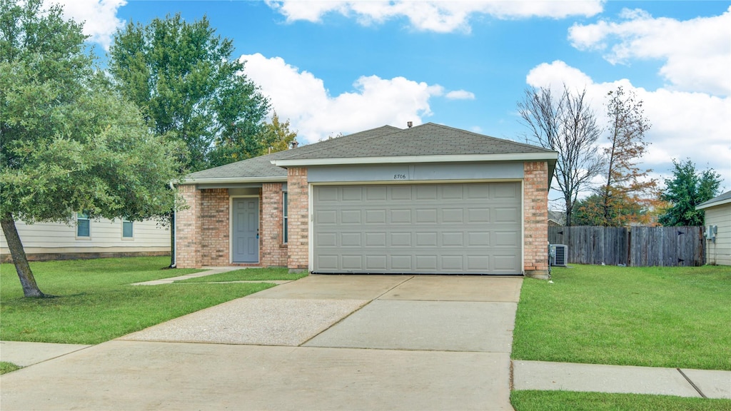 single story home with a garage and a front yard