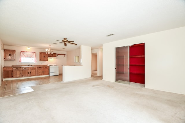 unfurnished living room with light colored carpet and ceiling fan with notable chandelier