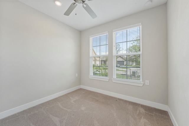 carpeted empty room featuring ceiling fan