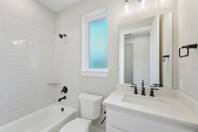 full bathroom with vanity, toilet, and tiled shower / bath combo