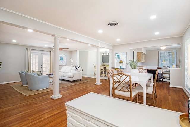 living room featuring wood-type flooring, ceiling fan with notable chandelier, french doors, and crown molding