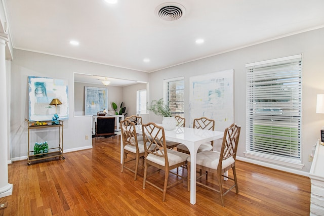 dining room featuring light wood-type flooring and crown molding