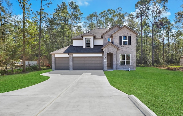 view of front of house featuring a garage and a front lawn