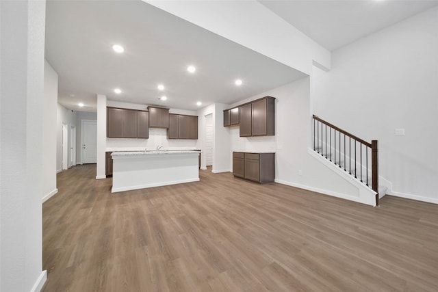 unfurnished living room featuring sink and dark hardwood / wood-style floors