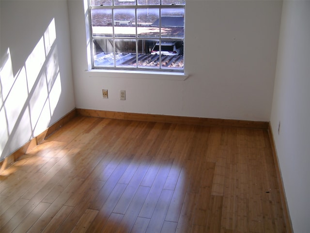 unfurnished room featuring hardwood / wood-style flooring