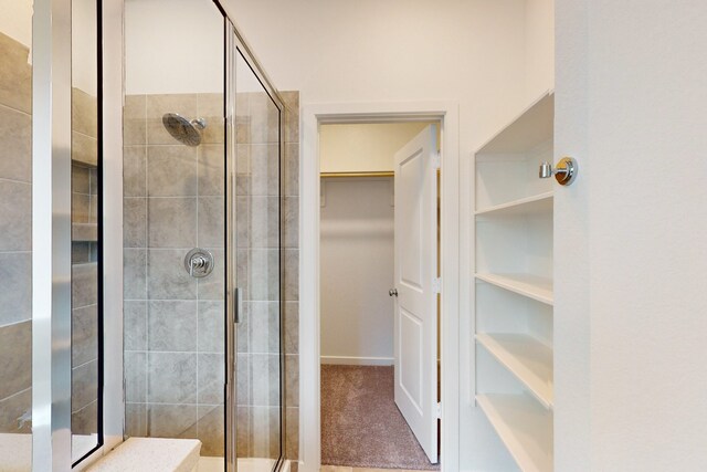 bathroom with a shower with door