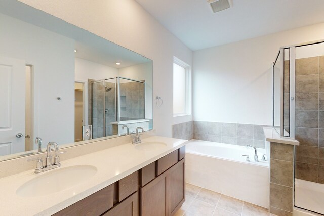 bathroom featuring tile patterned flooring, vanity, and independent shower and bath