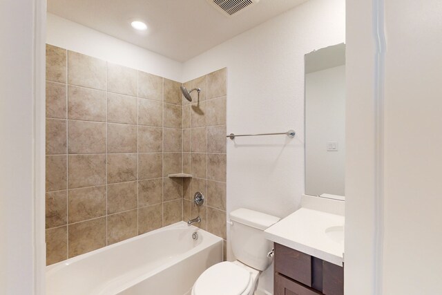 full bathroom with vanity, toilet, and tiled shower / bath combo