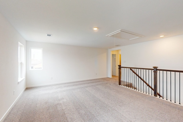 unfurnished room with light colored carpet