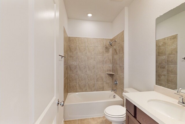 full bathroom featuring tiled shower / bath, tile patterned flooring, vanity, and toilet