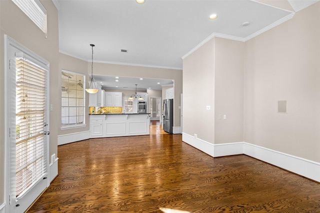 unfurnished living room with dark hardwood / wood-style flooring and crown molding