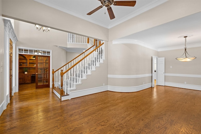 unfurnished living room featuring hardwood / wood-style floors, crown molding, and ceiling fan