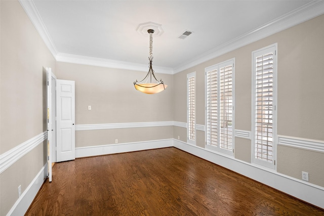 spare room featuring ornamental molding and dark hardwood / wood-style flooring