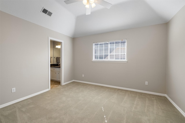 carpeted empty room with vaulted ceiling and ceiling fan