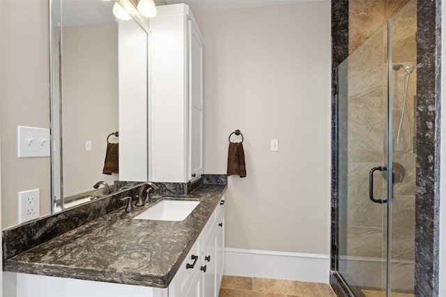 bathroom featuring tile patterned flooring, vanity, and a shower with shower door