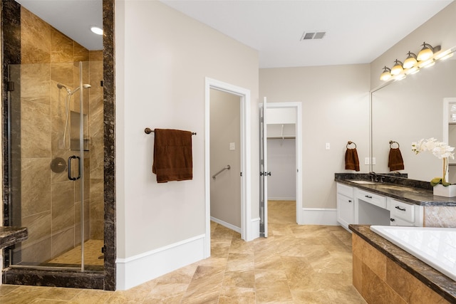 bathroom featuring shower with separate bathtub and vanity