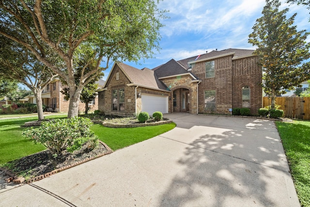 view of front of property with a garage and a front lawn