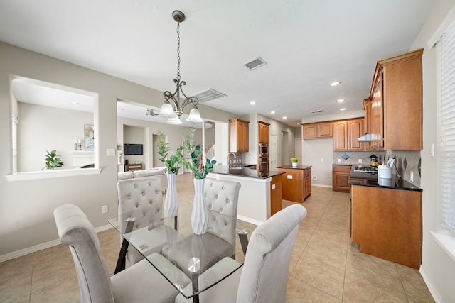 tiled dining area with sink and a notable chandelier