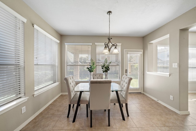 tiled dining area with a chandelier