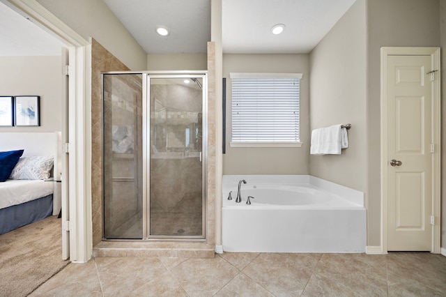 bathroom featuring tile patterned floors and shower with separate bathtub