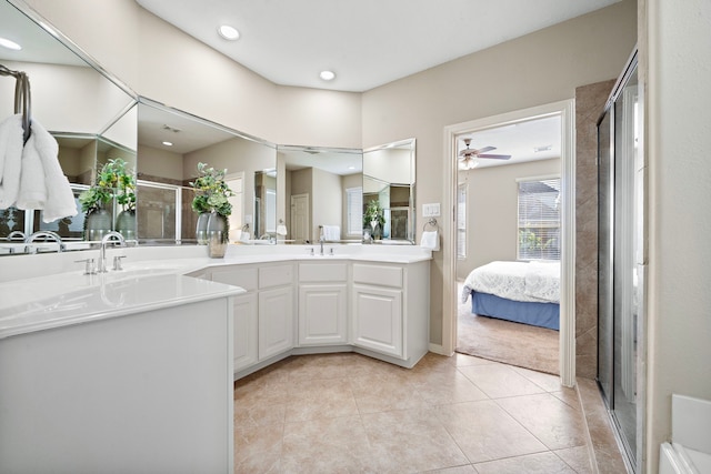 bathroom with tile patterned flooring, vanity, ceiling fan, and walk in shower