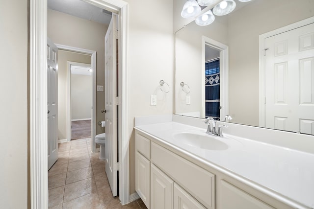 bathroom with tile patterned floors, vanity, and toilet