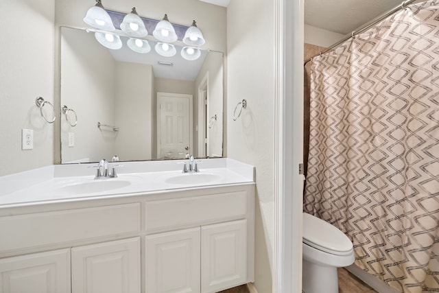 bathroom with vanity, toilet, and walk in shower