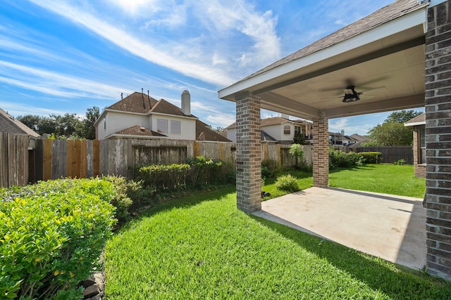 view of yard featuring ceiling fan and a patio