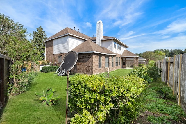 rear view of house with a yard