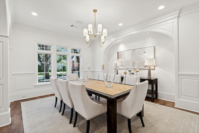 dining area featuring ornamental molding, dark hardwood / wood-style floors, and a chandelier