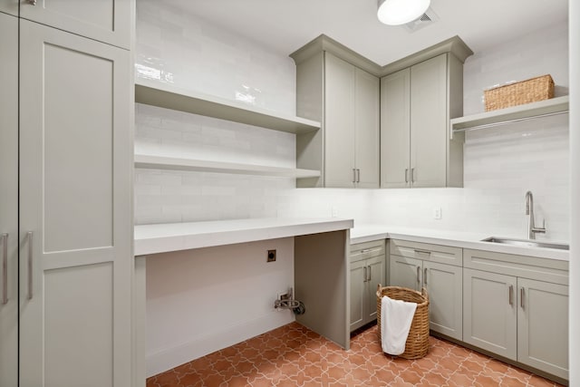 clothes washing area featuring cabinets, sink, and electric dryer hookup