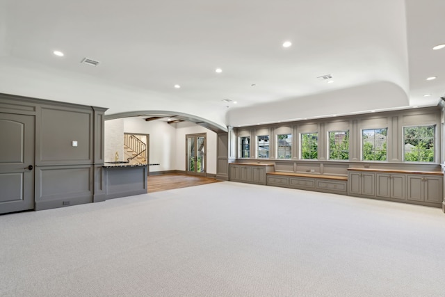 unfurnished living room with light colored carpet