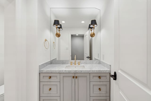 bathroom featuring vanity and toilet